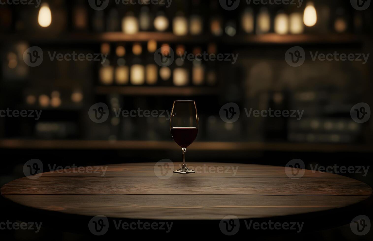 A glass of wine sits on a table in front of a bar photo