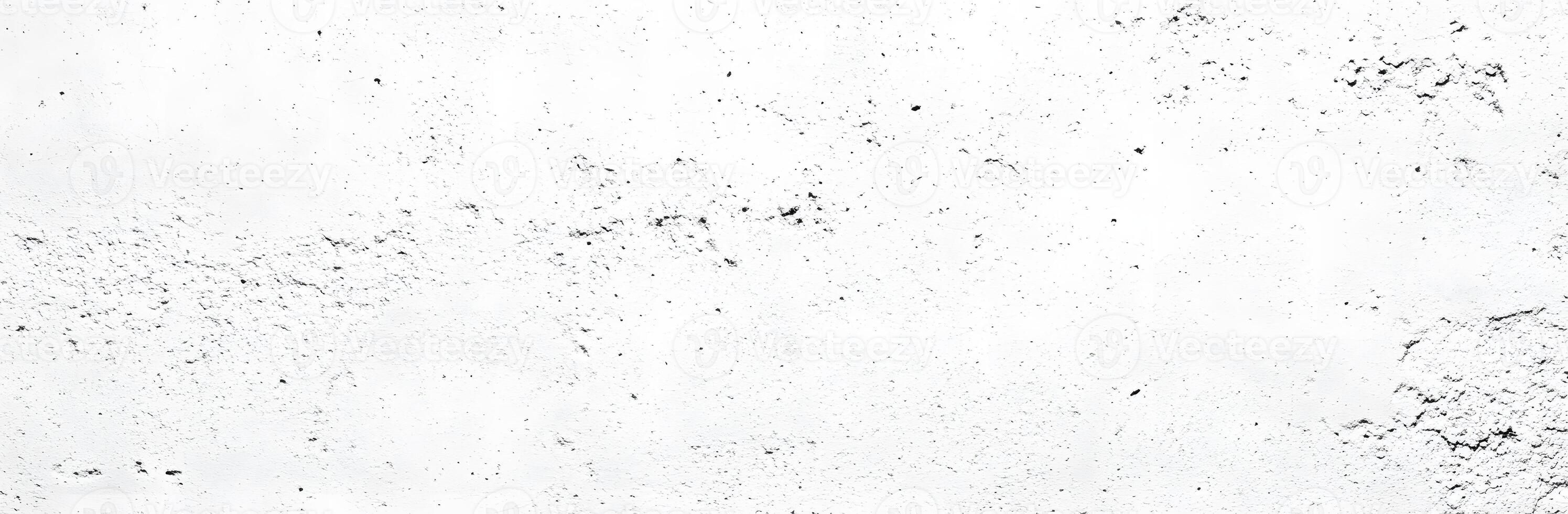 A white wall with black paint and a few spots photo