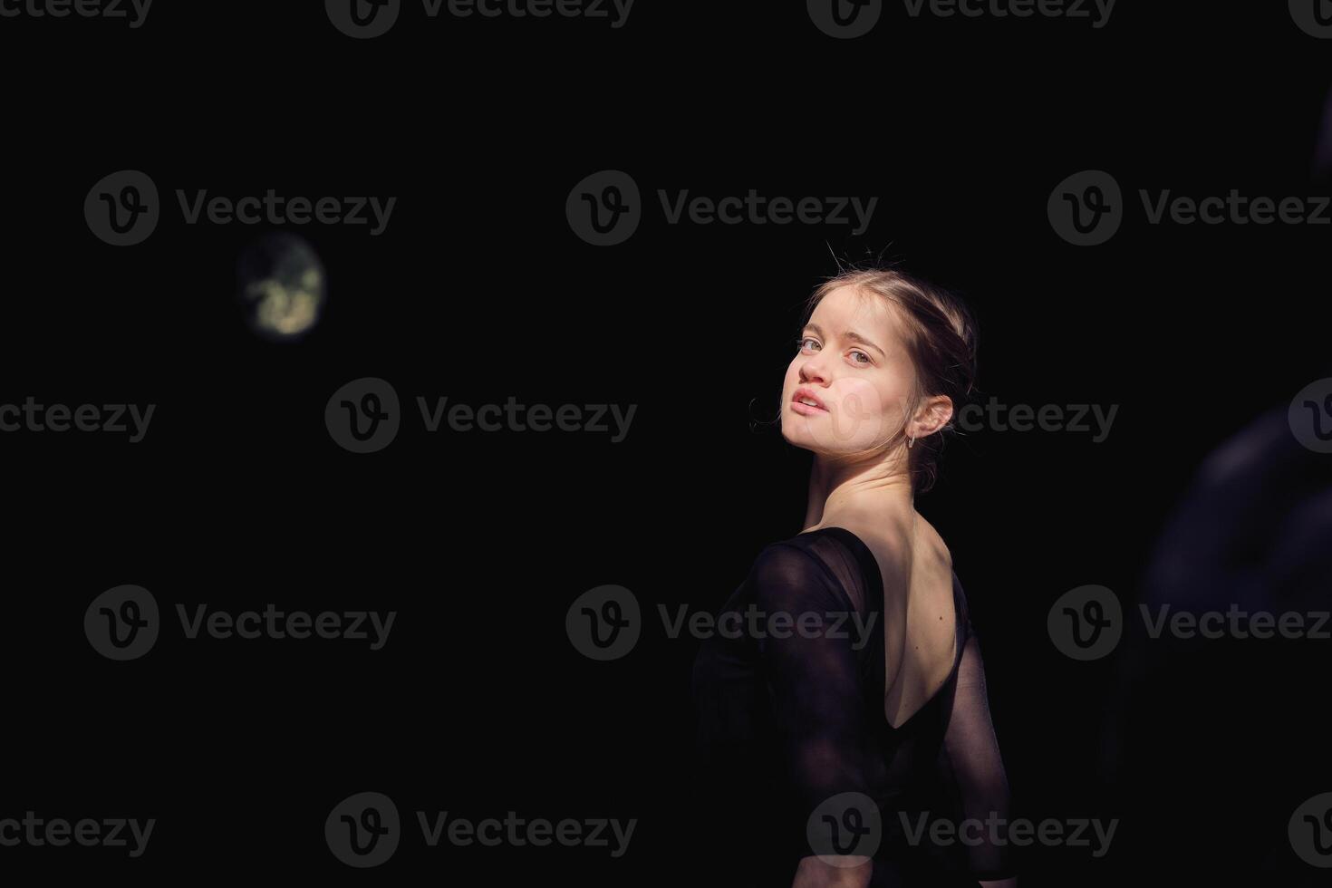 Charming ballerina in black outfit in nature photo