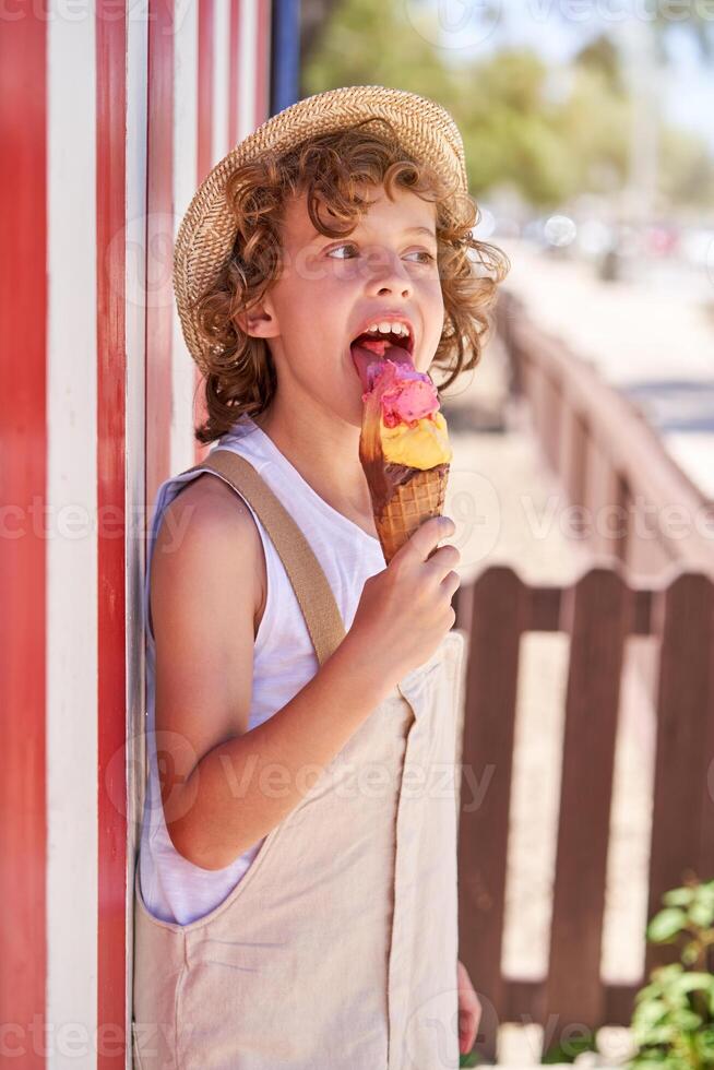 Boy eating ice cream outside photo