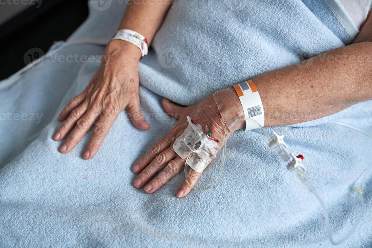 Crop unrecognizable mature woman with connected venous catheter photo