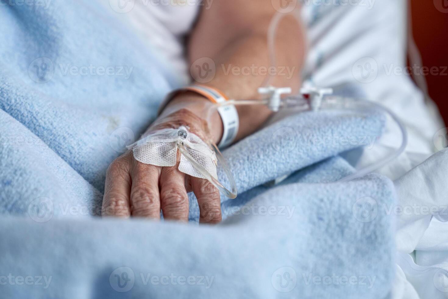 Unrecognizable patient with catheter on hand photo
