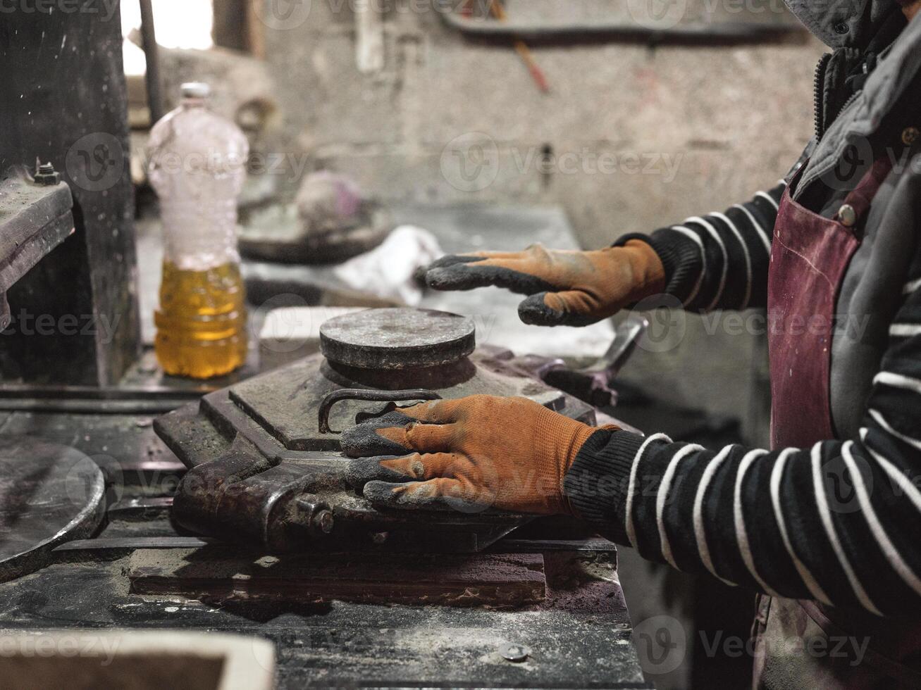 Unrecognizable man working with metal mold photo