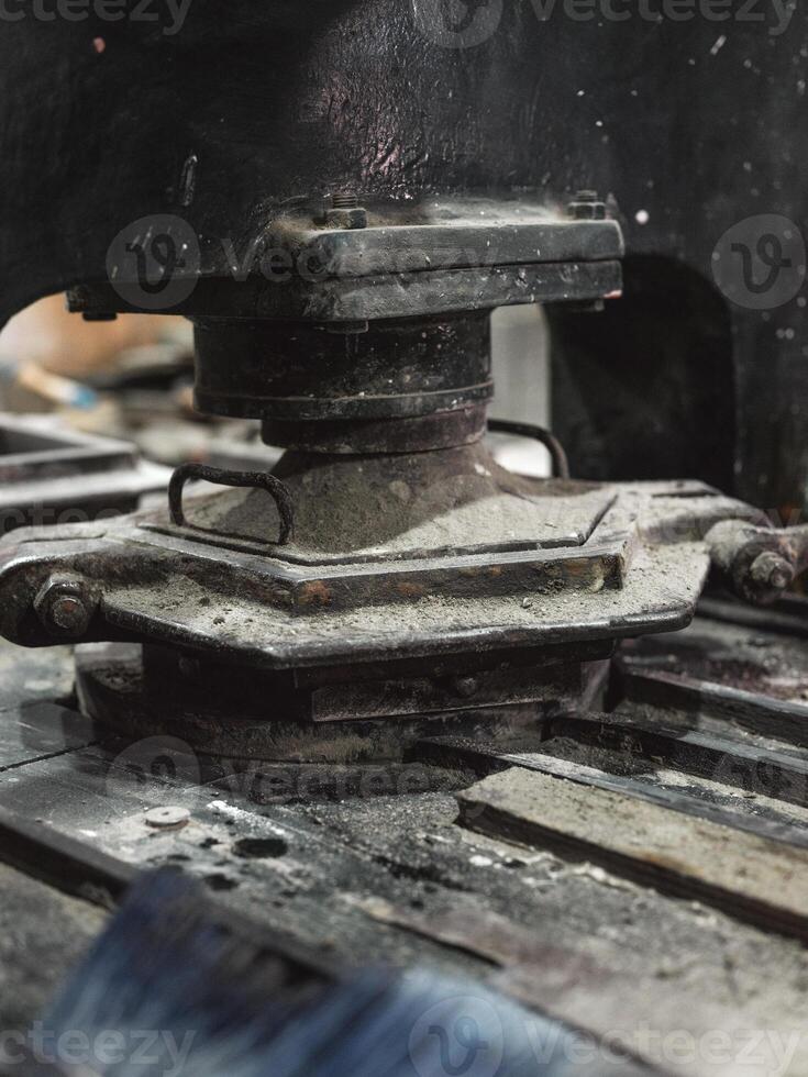 Metal pressing machine and tile mold in workshop photo