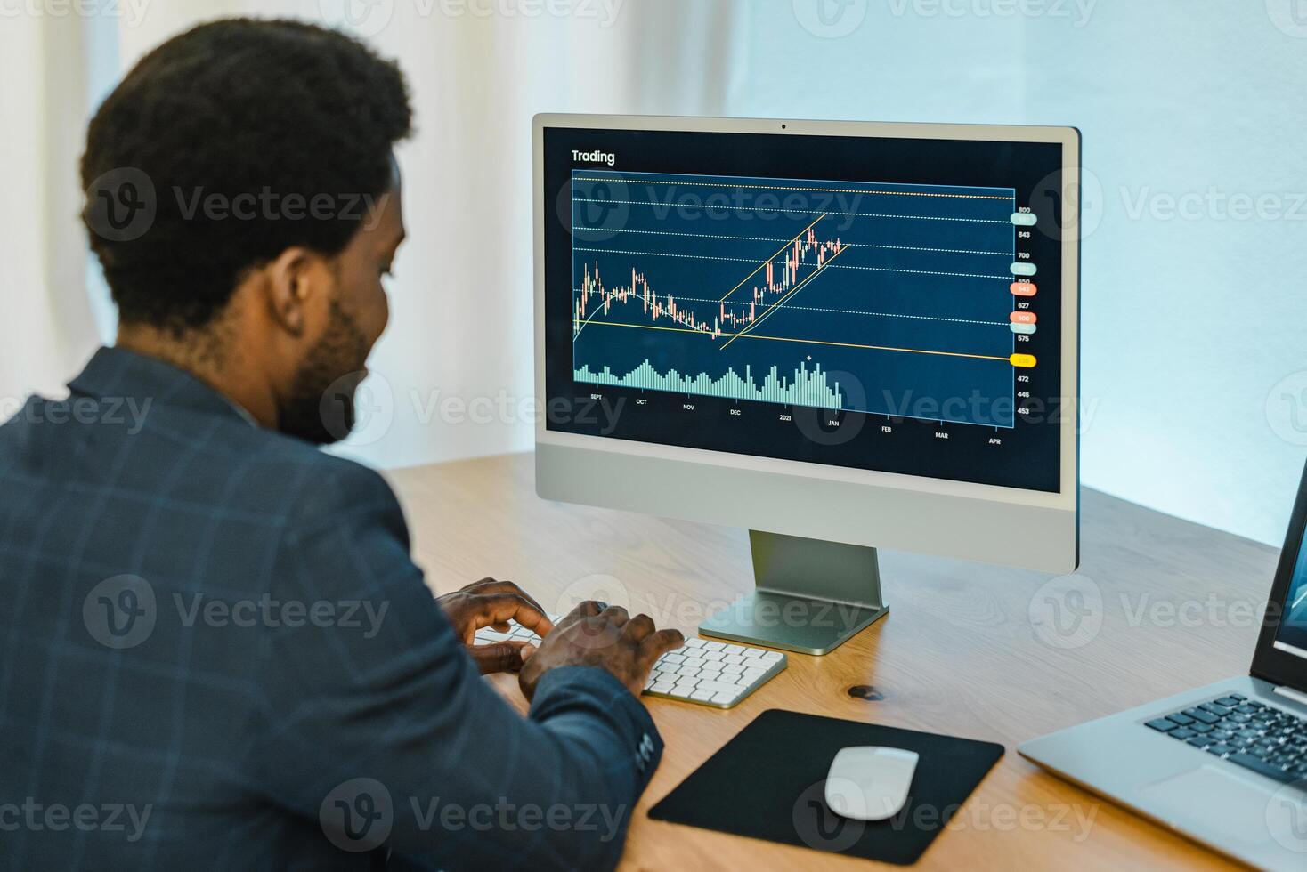Black male trader typing on keyboard photo