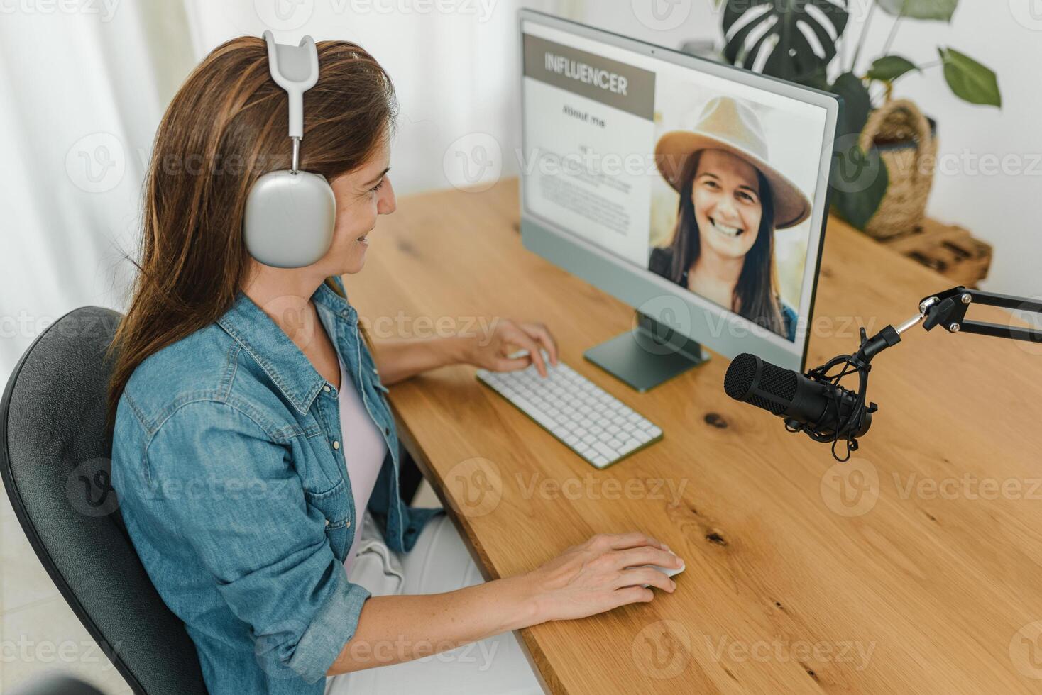 Radio host recording podcast and using computer photo