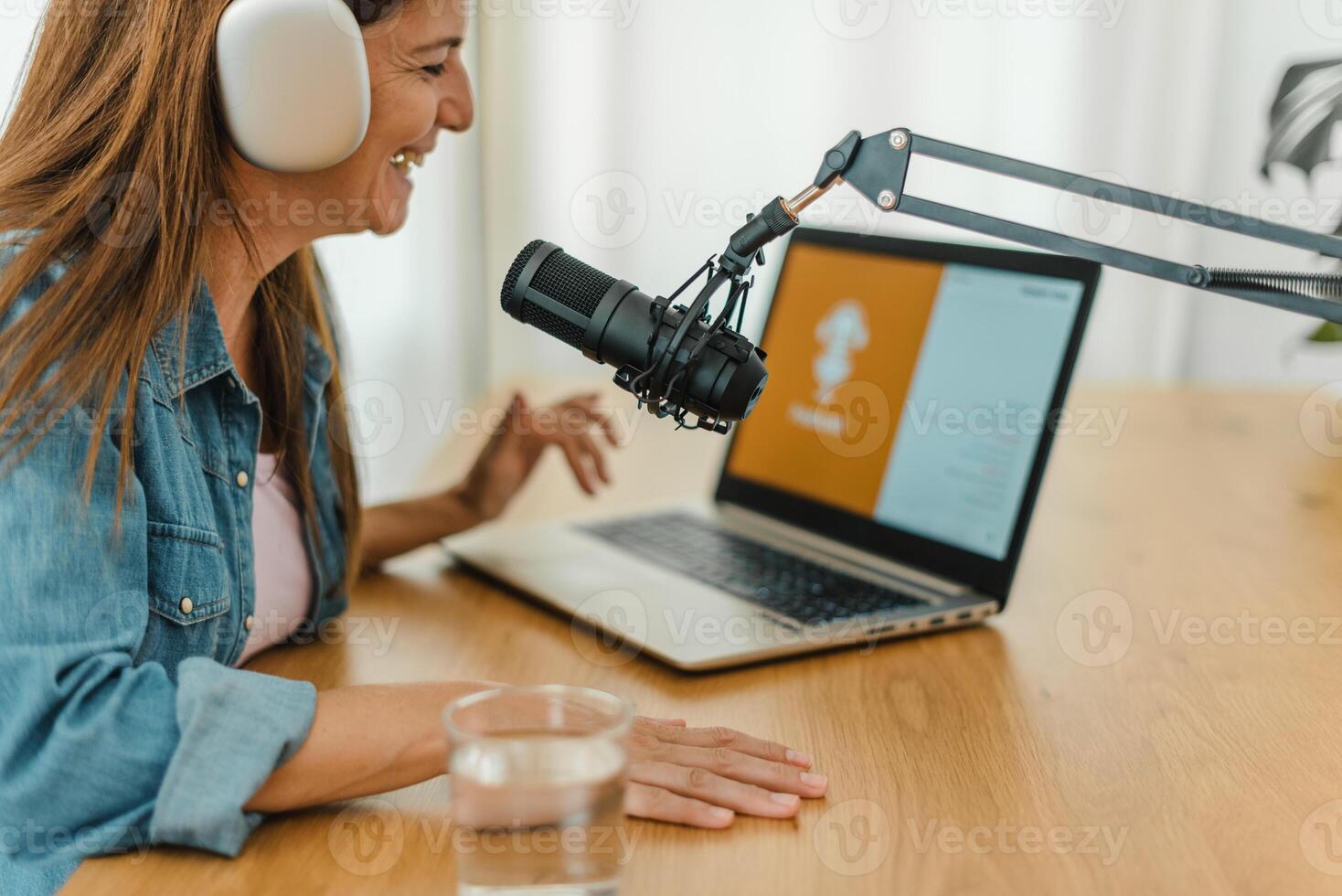 Woman in headphones recording podcast photo