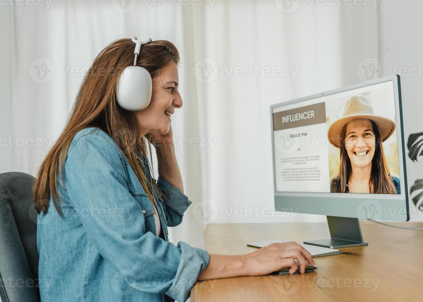 Woman in headphones using computer at home photo