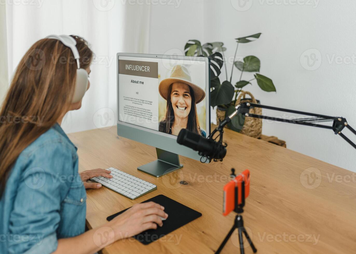 Female influencer using computer in recording studio photo