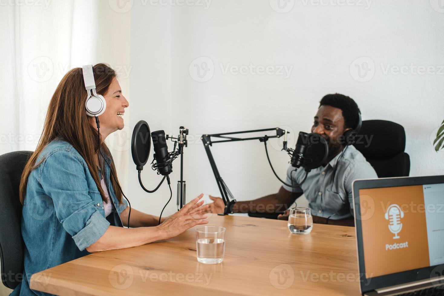 Multiethnic colleagues recording podcast in studio photo