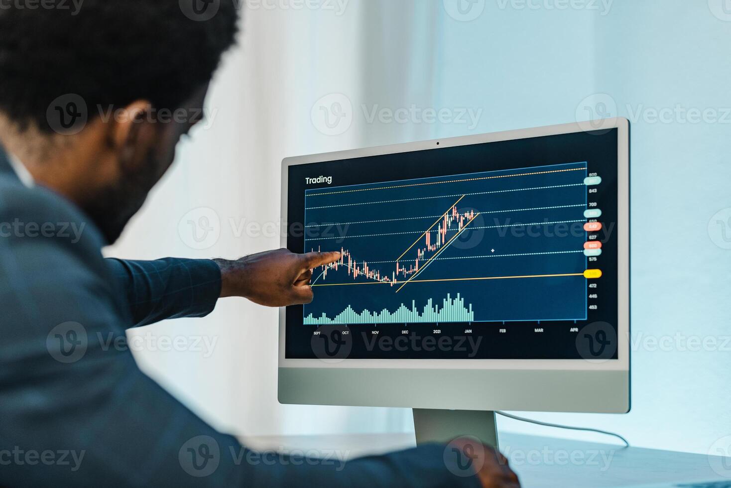Black man analyzing financial diagrams on binary option photo
