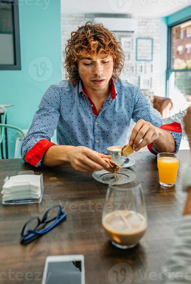 Young man eating breakfast photo