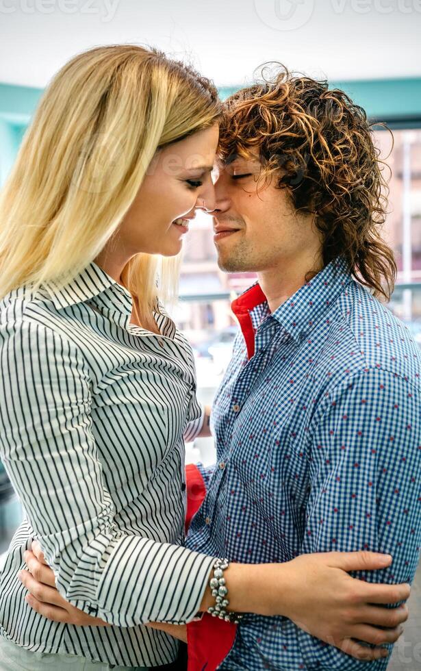Couple about to kiss in a cafe photo