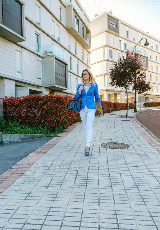 Businesswoman walking down the street photo