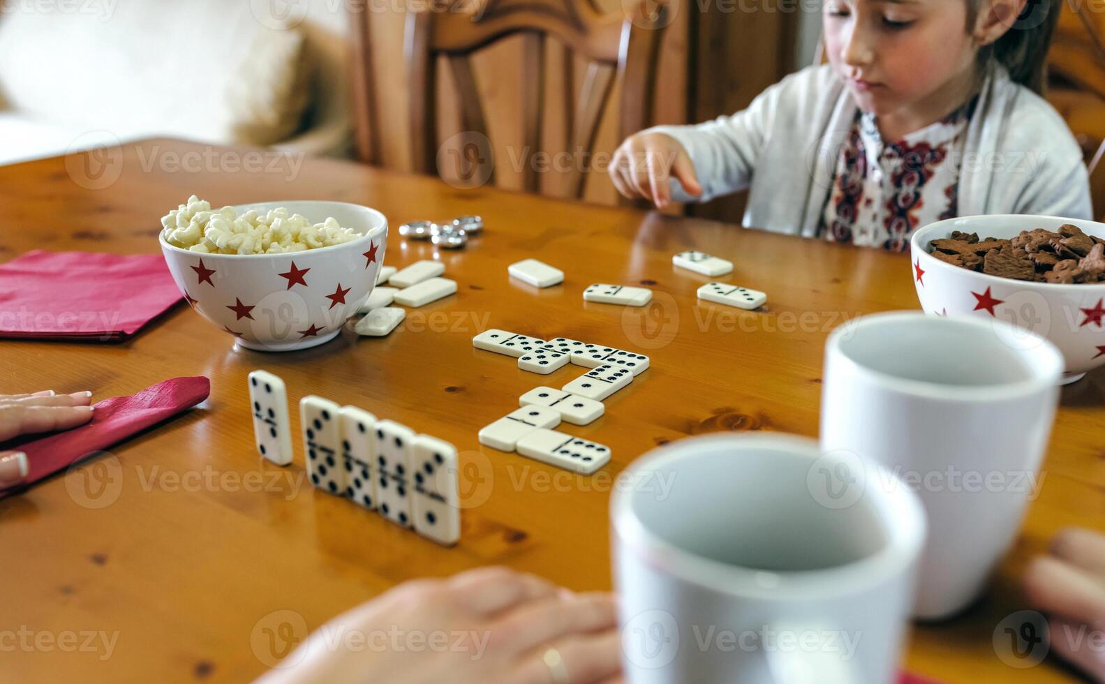 Girl playing domino with her family photo