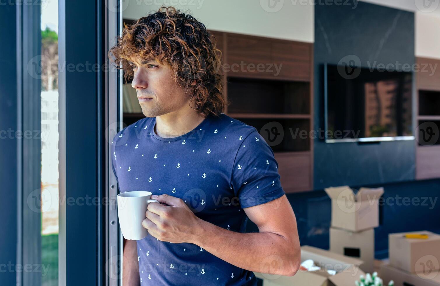 Man resting from unpacking moving boxes photo