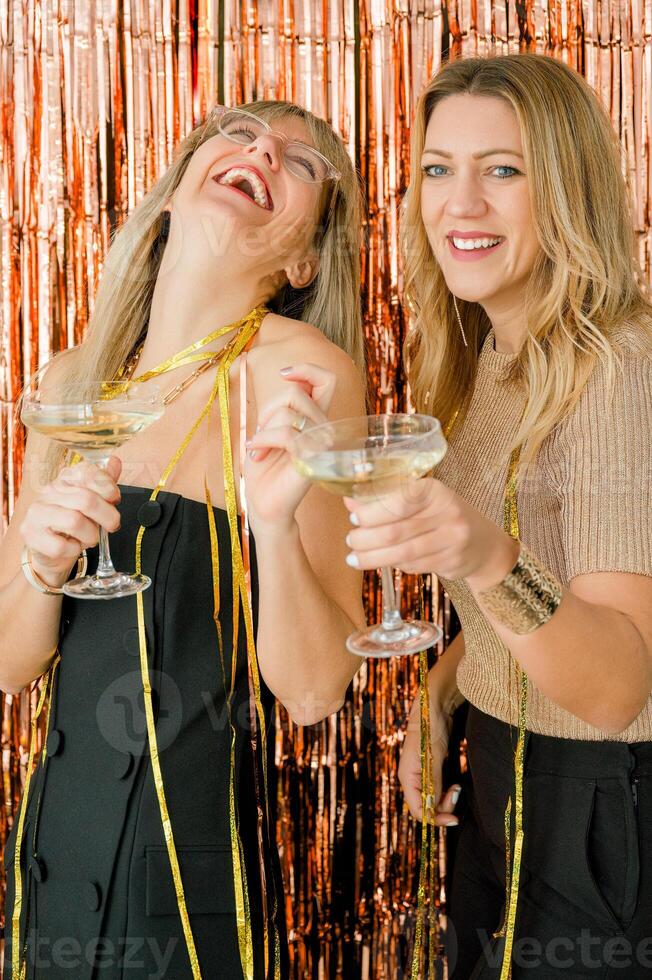 Cheerful women with champagne celebrating New Year photo