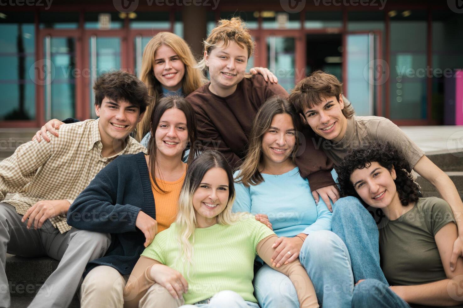 Delighted young friends cuddling and smiling at camera on street photo