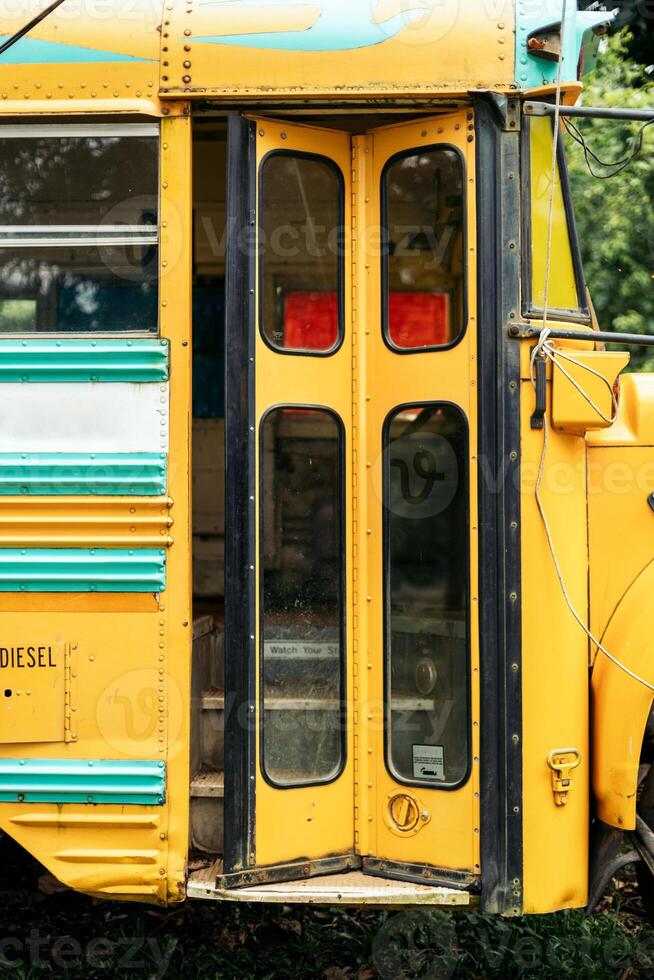 Vintage yellow school bus with the door partially open photo