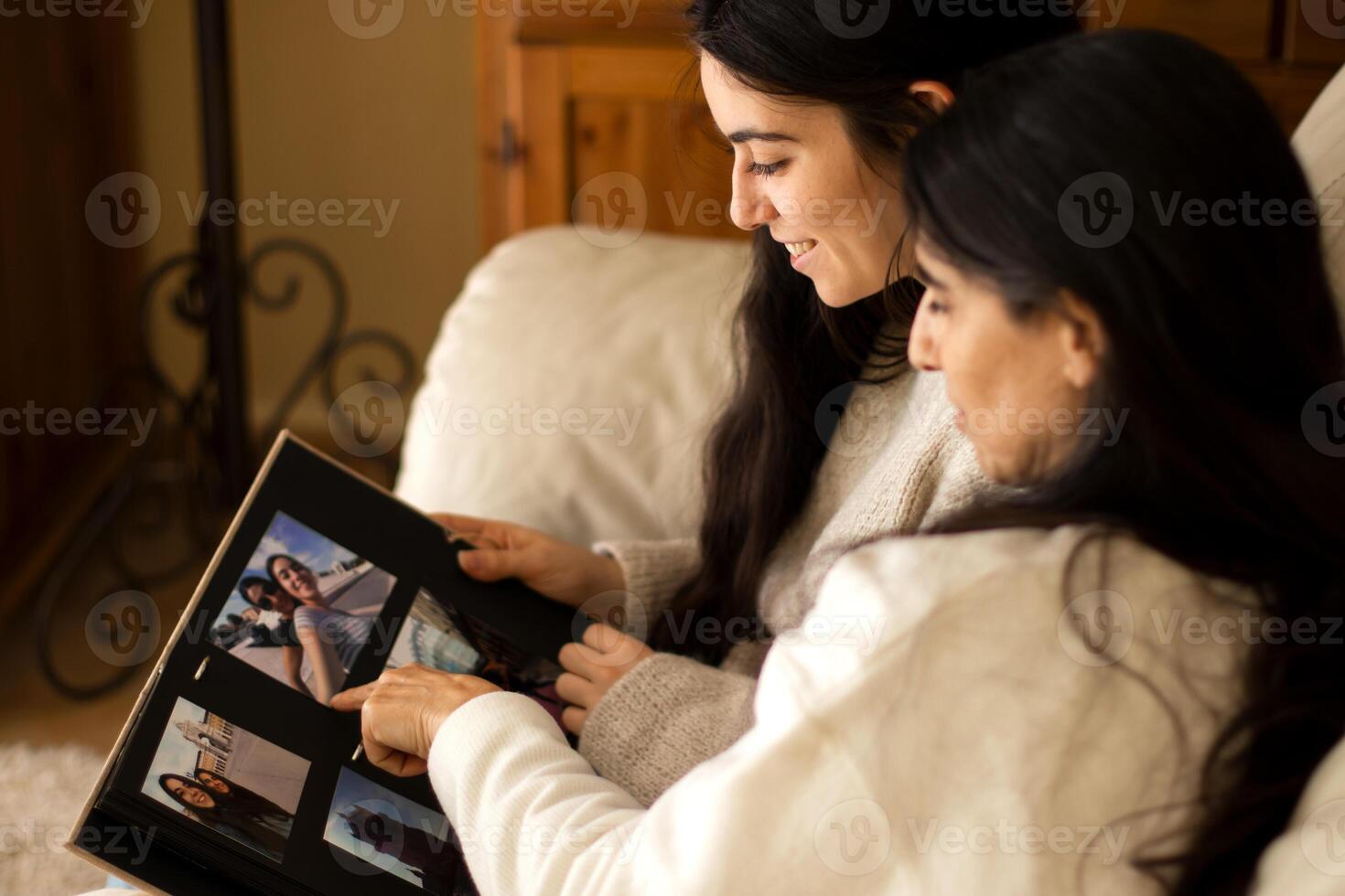 Family watching a photo album of themselves.