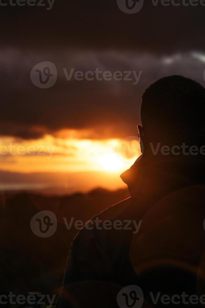 Man watching the sunset in the countryside in Costa Rica photo