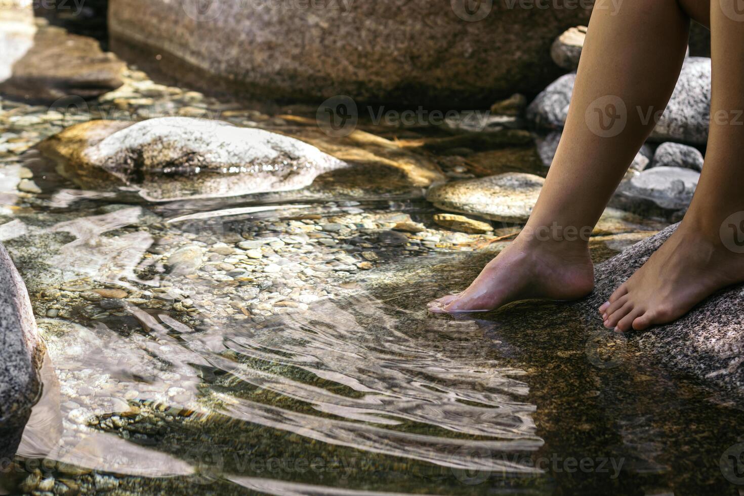 Close-up of a foot in the river water photo