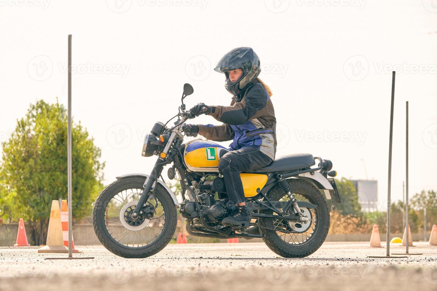 Woman riding motorcycle on motordrome photo
