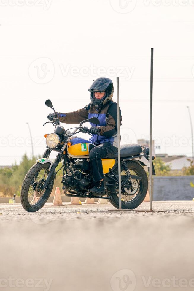 Serious biker riding motorcycle on motordrome photo