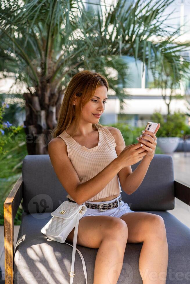 A woman reading something on her smartphone photo