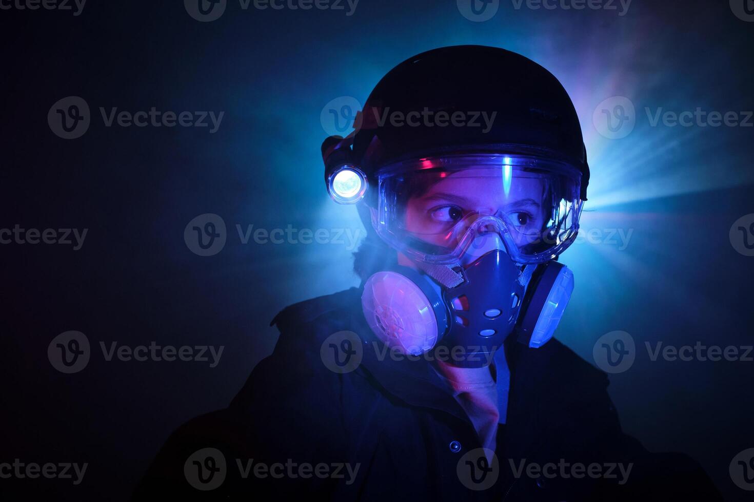 Thief in gas mask in darkness photo