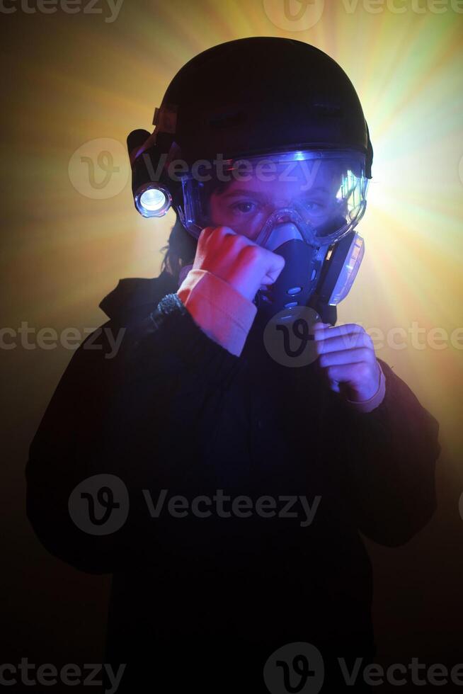 Boy in respirator with clenched fists photo