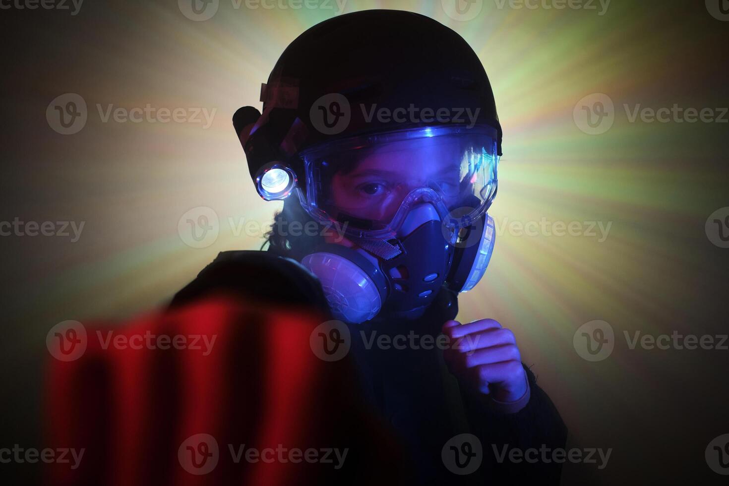 Boy in gas mask fighting with clenched fists photo