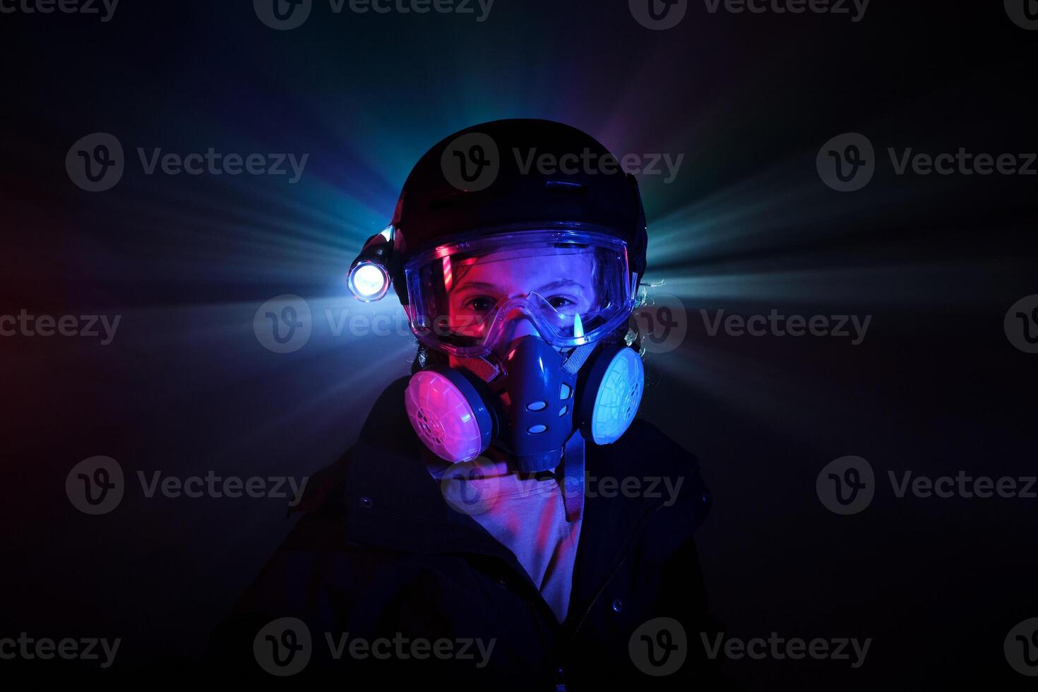 Thug in respirator standing in darkness photo