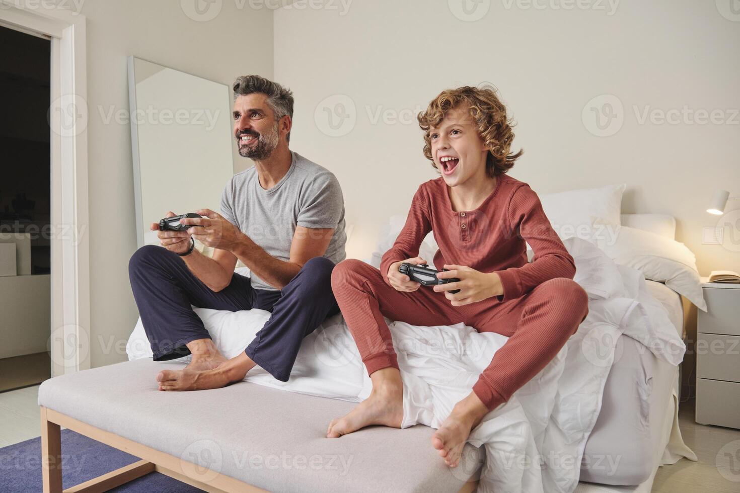 Happy man and child playing videogame at home photo