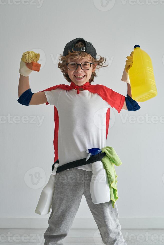 Excited superhero in red cape and cleaner costume in studio photo