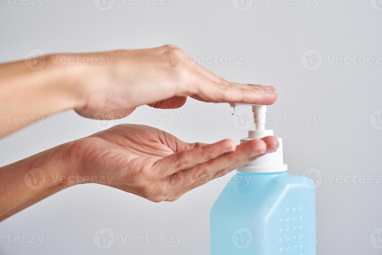 Anonymous person applying sanitizer on hand photo