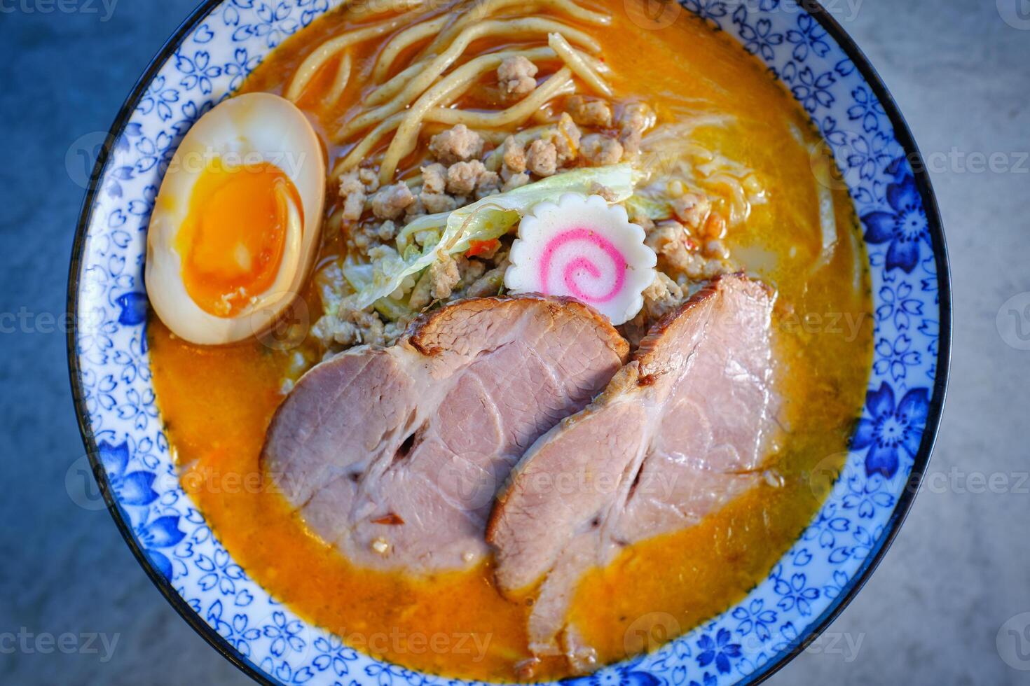 Bowl of delicious pork soup served on table photo