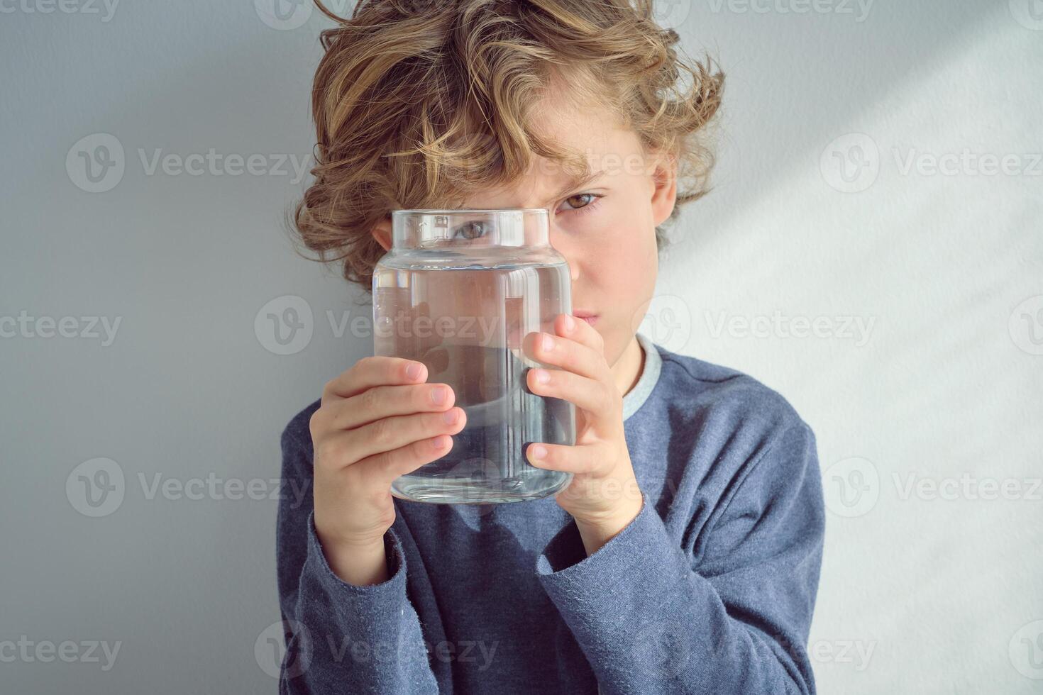 Blond haired boy with jar of water photo