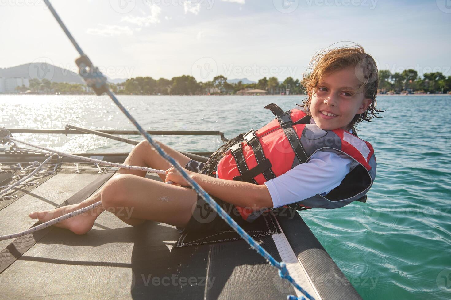 Content child smiling during cruise on yacht photo
