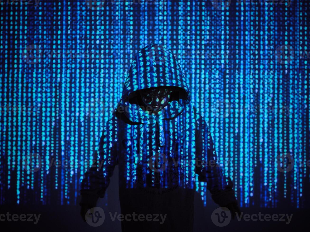 Programmer boy standing in blue code photo