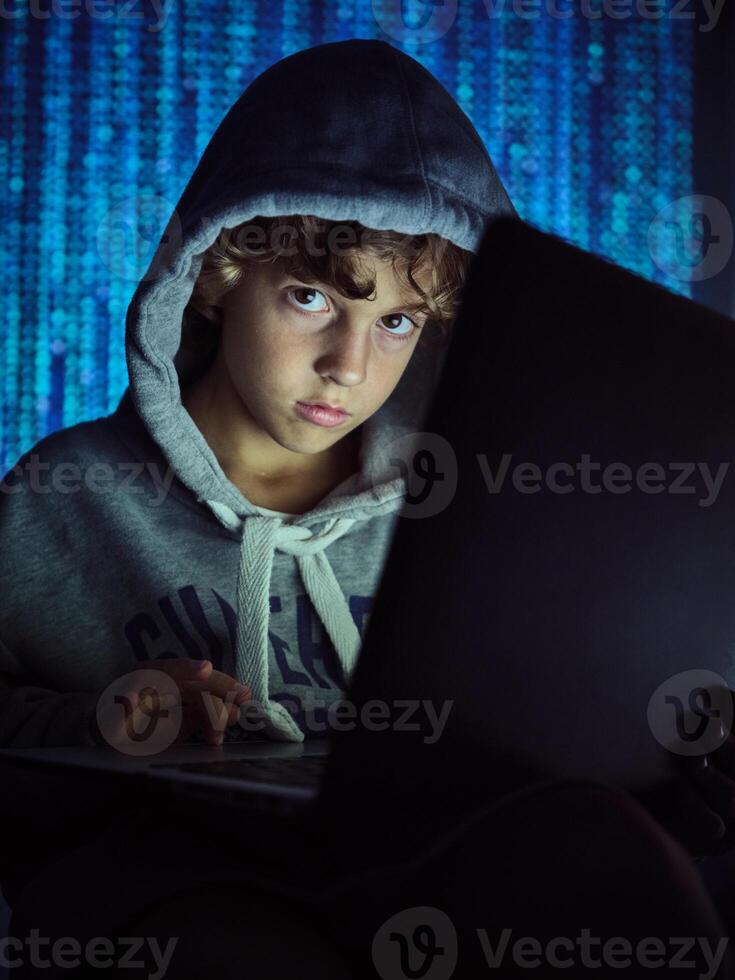 Boy using laptop on binary code background photo