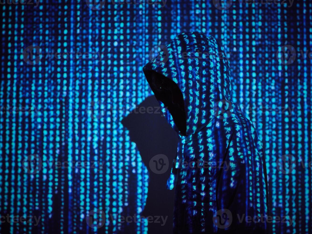 Coder standing on background of computer symbols photo
