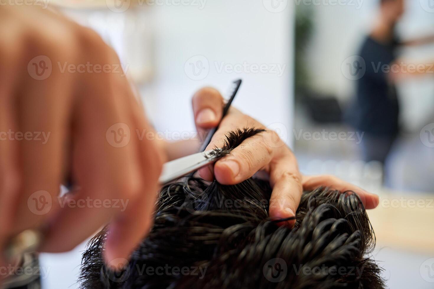 Crop hairstylist cutting hair of client photo