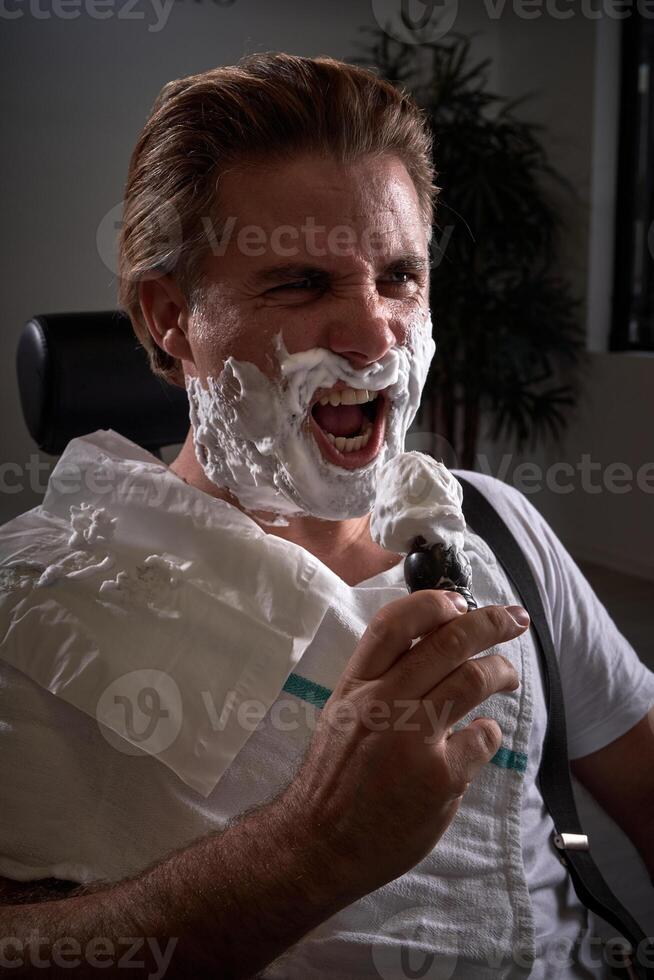 Man with foamy beard pretending to sing photo