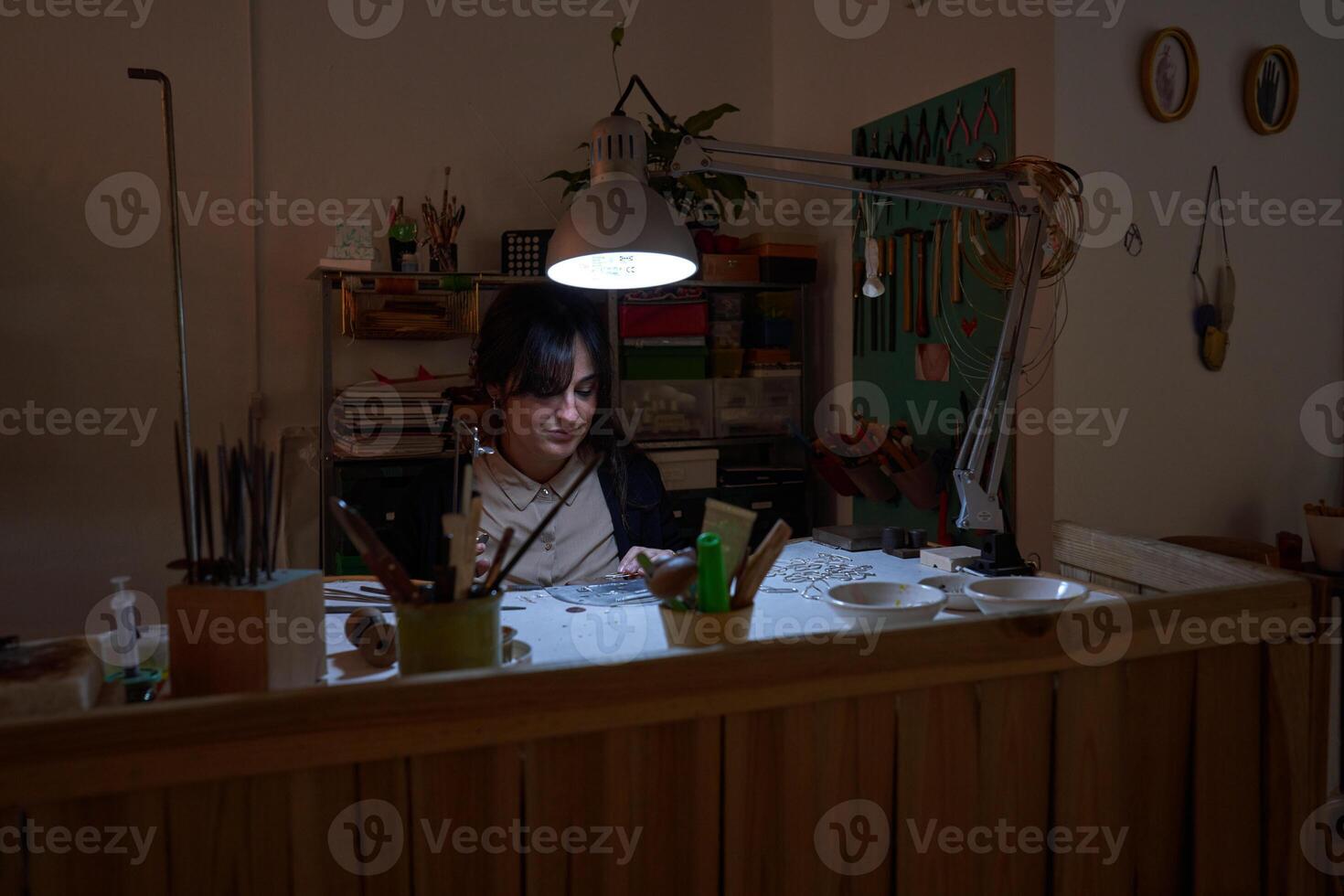 Female jeweler working in workshop photo