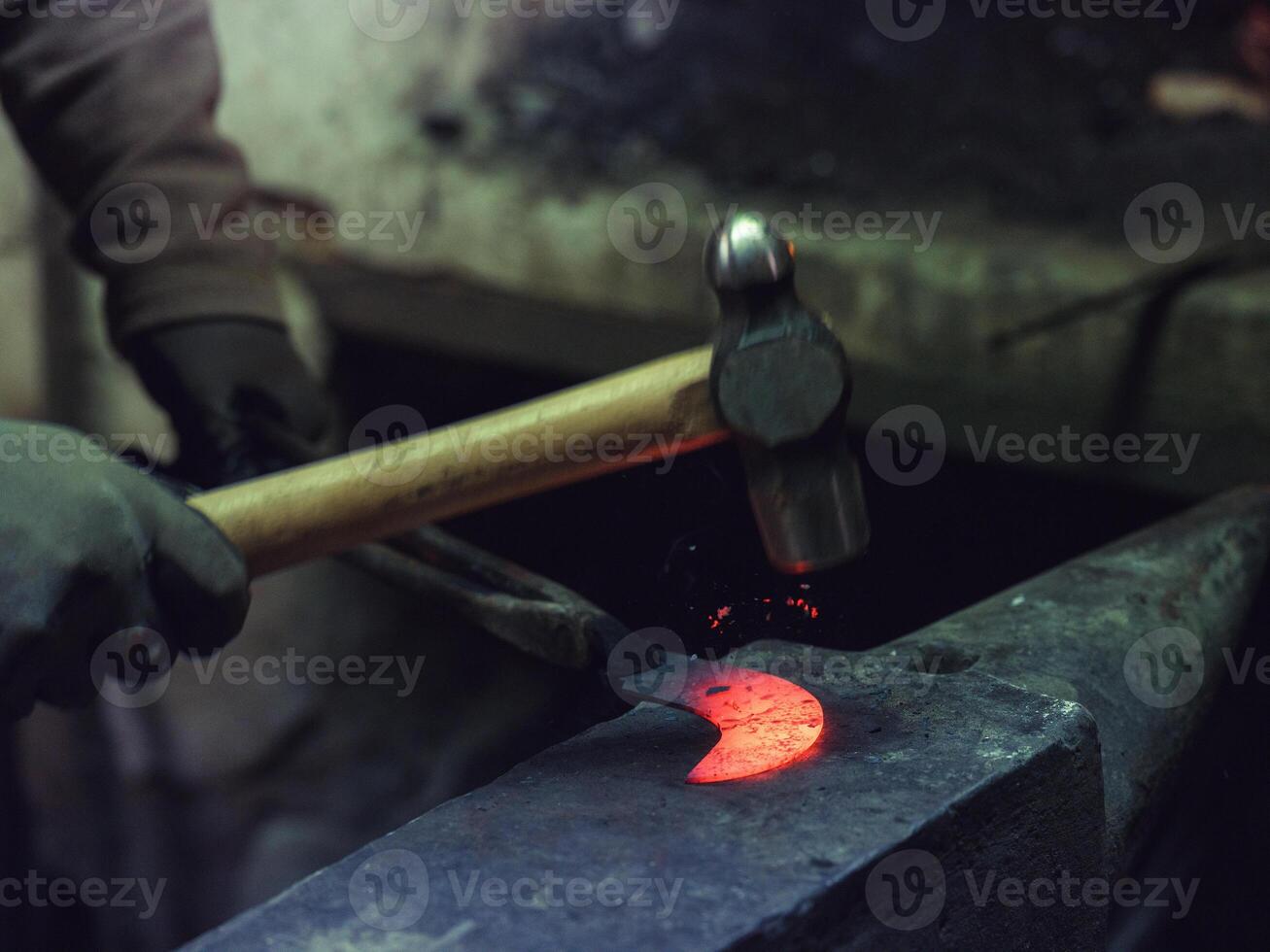 Crop farrier forging iron in workshop photo