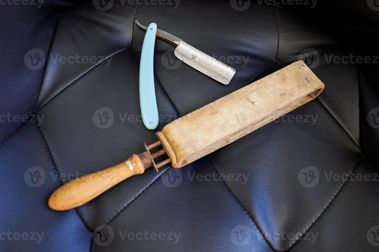 Old fashioned razor with razor strop on couch photo