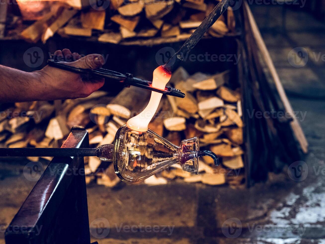 Unrecognizable craftsman making glass teapot photo