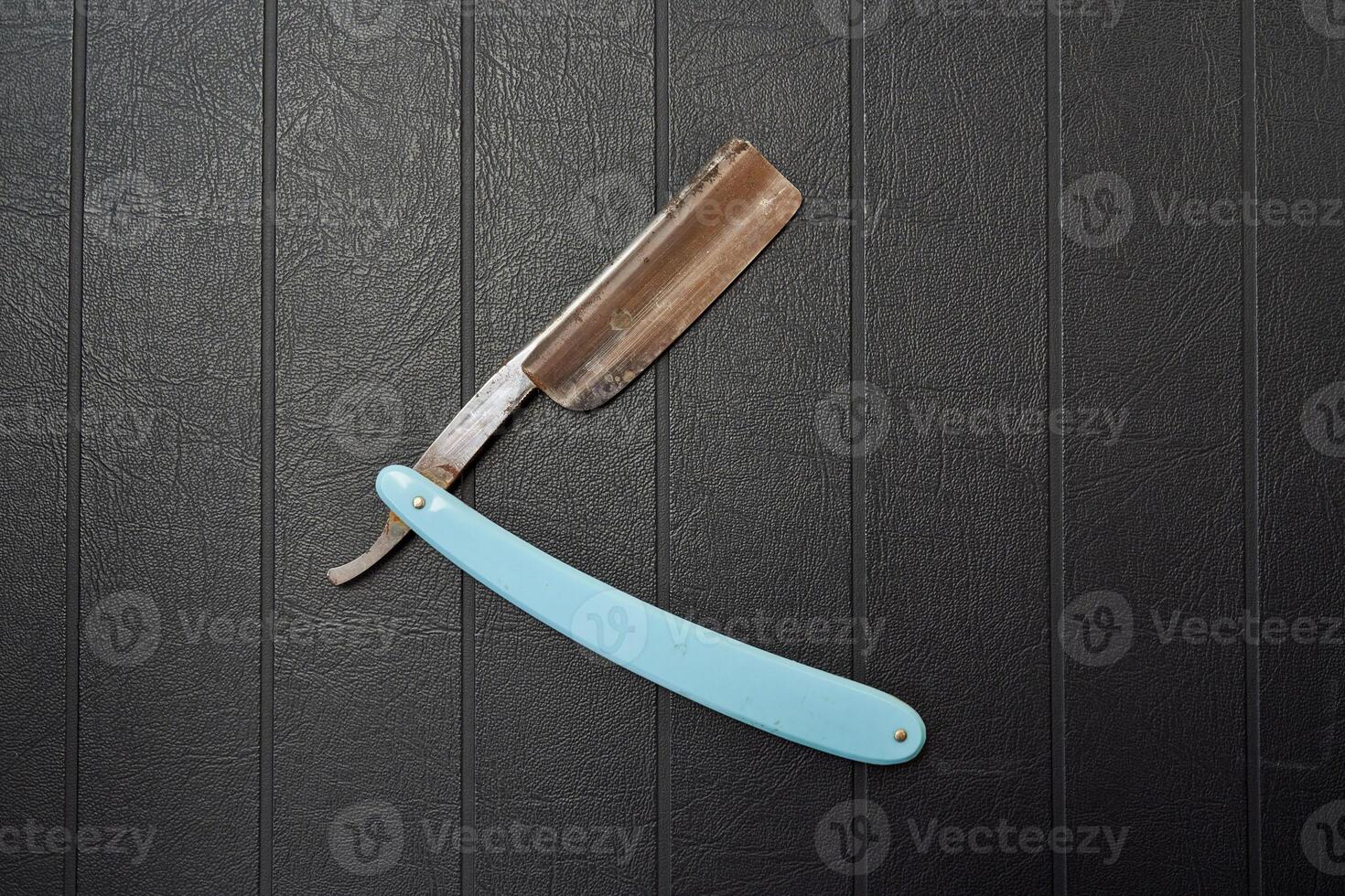 Rusty metal razor on black background photo