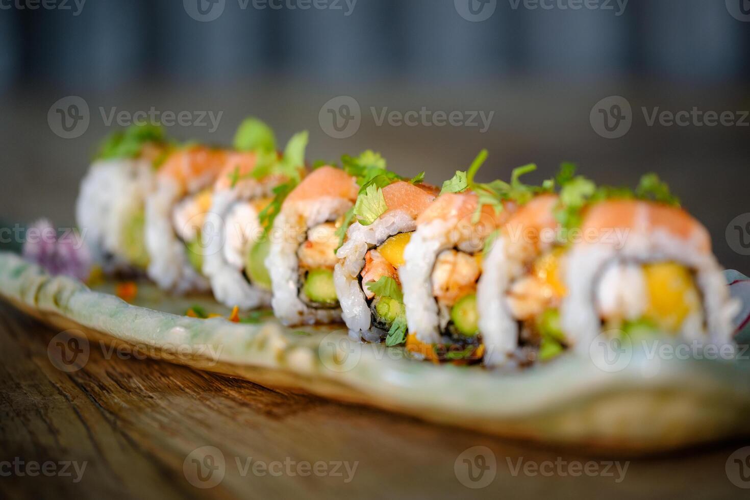 sUramaki sushi with salmon and fresh vegetable with avocado on marble tray photo